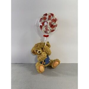 Collectible Christmas ornament featuring a teddy bear holding A Lollipop Holiday